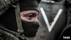 Російський військовий на тлі символіки повномасштабного вторгнення РФ в Україну, ілюстративне фото