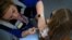 FRANCE-HEALTH-VACCINATION-HPV-PAPILLOMAVIRUS-EDUCATION/ A nurse injects a dose of human papillomavirus (HPV) vaccine at Theodore Monod college in Vern-sur-Seiche, suburb of Rennes, western France on October 9, 2023.