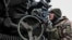 UKRAINE – A Ukrainian service member prepares to shoot from a howitzer at a front line, as Russia's attack on Ukraine continues, in Zaporizhzhia Region, December 16, 2022