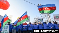 Azerbaijani pro-government activists block a road connecting Nagorno-Karabakh to Armenia, December 26, 2022.