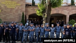 Armenia - Riot police guard the entrance to the Investigative Committee headquarters in Yerevan, June 27, 2025.