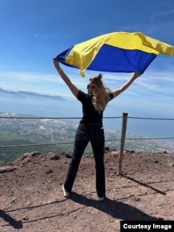 Наталя з українським прапором, який вона всюди возить із собою. Везувій, Італія, весна 2024 року