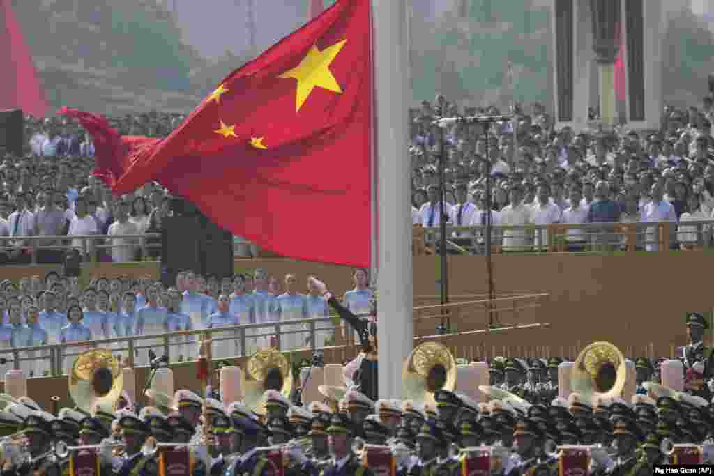 Flamuri kinez duke u ngritur para fillimit të paradës ushtarake.
