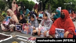 د بلوڅانو په پرلت کې ښځو او ماشومانو د کورنیو د ورکو غړو انځورونه نیولي دي - د جولای ۲۲مې انځور.