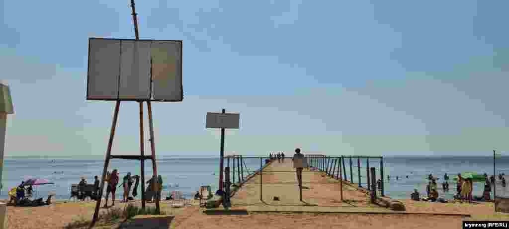 Аварійний причал на пляжі, де незважаючи на заборону, гуляють люди