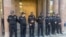 Armenia - Police officers guard the entrance to an Investigative Committee building in Yerevan where a number of priests were taken for questioning, October 15, 2025.