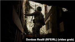 Військовослужбовець ЗСУ прислухається до звуку дрона, який пролетів повз позицію артилерії