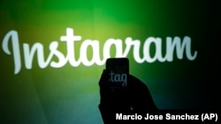 U.S. -- A journalist makes a video of the Instagram logo - generic