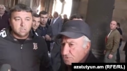 Armenia - Supporters of a defrocked priest harass reporters at the Hovanavank monastery, October 23, 2025.